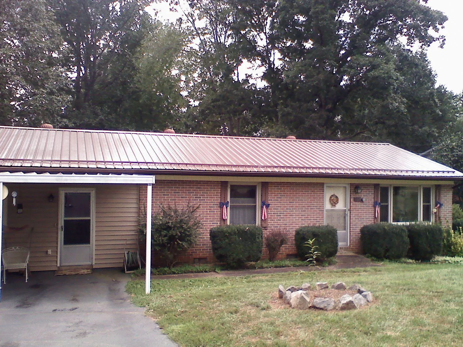 Bronze metal roof and carport on a brick ranch home — Roof Repair work by our crew in Valley Springs